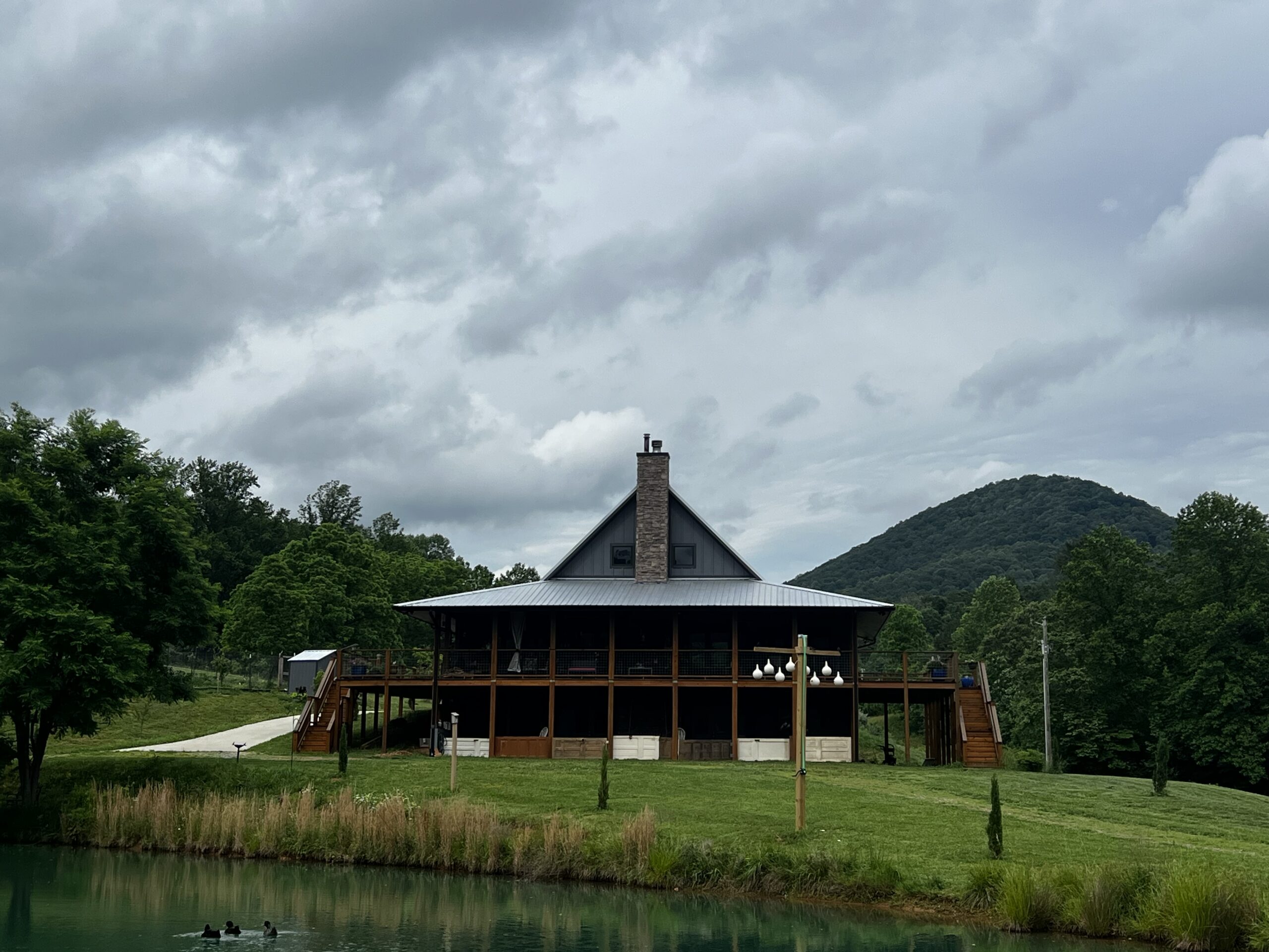 Custom mountain lodge with wraparound porch overlooking a pond near Blairsville Georgia Custom mountain lodge with wraparound porch overlooking a pond near Blairsville Georgia
