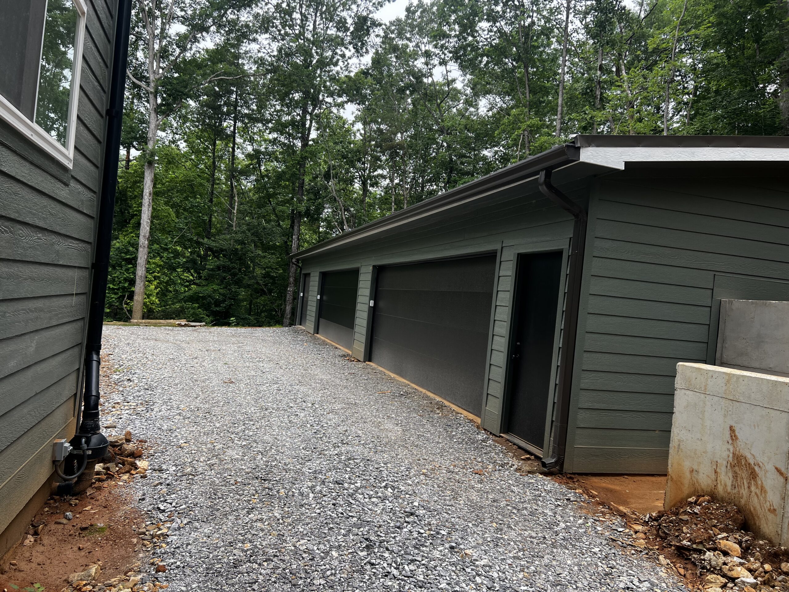 Detached garage and workshop matched to the main house siding and roofline Detached garage and workshop matched to the main house siding and roofline